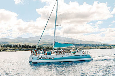 Catamaran sailing along the scenic West Maui coastline during a Kaanapali snorkel tour